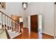 Elegant foyer featuring hardwood floors, a staircase, and a decorative front door at 12917 Brighton Ln, Carmel, IN 46032