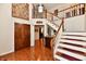 Grand foyer featuring hardwood floors, a staircase, and elegant decor at 12917 Brighton Ln, Carmel, IN 46032