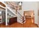 Spacious foyer with hardwood flooring, staircase with white railing, and stylish decor at 12917 Brighton Ln, Carmel, IN 46032