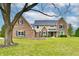 Charming two-story brick home with well-manicured lawn and mature tree in a suburban setting at 12917 Brighton Ln, Carmel, IN 46032