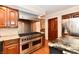 Modern kitchen with stainless steel appliances, granite counters, and a commercial grade range at 12917 Brighton Ln, Carmel, IN 46032