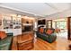 Comfortable living room with a brick fireplace, built-in shelves, and an open doorway at 12917 Brighton Ln, Carmel, IN 46032