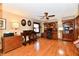 Comfortable office features hardwood floors, ceiling fan, built-in shelving, and a wooden desk at 12917 Brighton Ln, Carmel, IN 46032