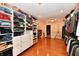 Spacious walk-in closet with custom shelving and hardwood flooring for organized storage at 12917 Brighton Ln, Carmel, IN 46032
