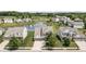 Aerial view of a residential neighborhood with well-maintained lawns, mature trees, and a scenic pond at 12959 Balfour Rd, Fishers, IN 46037