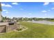 View of deck and patio facing the water feature and community area at 12959 Balfour Rd, Fishers, IN 46037