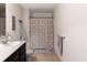 Bright bathroom featuring a vanity, tile floors, and shower with patterned curtain at 12959 Balfour Rd, Fishers, IN 46037
