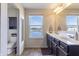 Bathroom featuring double vanity, large mirror, toilet in separate room, and great view of the backyard at 12959 Balfour Rd, Fishers, IN 46037