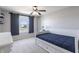 This bright bedroom features a bed with built-in storage, a ceiling fan, and barn door window coverings at 12959 Balfour Rd, Fishers, IN 46037