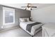 Modern bedroom with gray accent wall, plush bed, and bright natural light from the window at 12959 Balfour Rd, Fishers, IN 46037