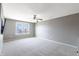 This large bedroom has neutral carpet, a ceiling fan, and a window for natural light at 12959 Balfour Rd, Fishers, IN 46037