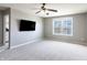 This spacious bedroom features neutral carpet, a ceiling fan, and plenty of natural light at 12959 Balfour Rd, Fishers, IN 46037