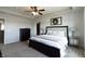 Beautiful bedroom featuring a ceiling fan, a large bed, and a decorative shiplap accent wall at 12959 Balfour Rd, Fishers, IN 46037