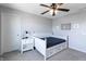 Neutral toned bedroom featuring a white bed, nightstand, ceiling fan, and carpeted floors at 12959 Balfour Rd, Fishers, IN 46037