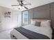 Cozy bedroom features decorative accent wall, ceiling fan, plush bed, and natural lighting at 12959 Balfour Rd, Fishers, IN 46037