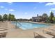 A community pool with tan lounge chairs and umbrellas at 12959 Balfour Rd, Fishers, IN 46037