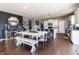 Bright open-concept dining area features a large table, wood floors, and stylish decor, perfect for Gathering gatherings at 12959 Balfour Rd, Fishers, IN 46037
