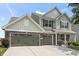Traditional style two-story home featuring a two-car garage, well-manicured lawn, and mature trees at 12959 Balfour Rd, Fishers, IN 46037