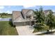 A charming two-story home features a well-manicured lawn, pond and an attached two-car garage at 12959 Balfour Rd, Fishers, IN 46037