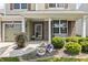 The charming front porch features brick accents, a white bench, and lush landscaping at 12959 Balfour Rd, Fishers, IN 46037
