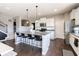 Bright open-concept kitchen features a large island, granite counters, and stainless steel appliances at 12959 Balfour Rd, Fishers, IN 46037