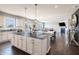 Spacious open-concept kitchen, dining, and living area, featuring a large island and stainless steel appliances at 12959 Balfour Rd, Fishers, IN 46037