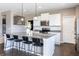 Bright kitchen with an island, granite counters, stainless steel appliances, and stylish pendant lighting at 12959 Balfour Rd, Fishers, IN 46037