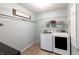 Functional laundry room with modern washer and dryer, overhead shelving, and light blue walls at 12959 Balfour Rd, Fishers, IN 46037