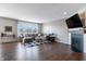 Comfortable living room with hardwood floors, a large window, and a cozy fireplace feature at 12959 Balfour Rd, Fishers, IN 46037