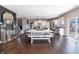 Large dining area with modern table and chairs, hardwood floors, an adjacent kitchen, and elegant finishes at 12959 Balfour Rd, Fishers, IN 46037