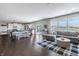 Spacious living area featuring hardwood floors, a comfortable sofa, and an open layout to the kitchen at 12959 Balfour Rd, Fishers, IN 46037