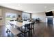 Open concept living area with a dining table, hardwood floors, and modern finishes throughout at 12959 Balfour Rd, Fishers, IN 46037