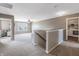 Open loft area with neutral carpet and paint, with access to seating and laundry room at 12959 Balfour Rd, Fishers, IN 46037