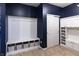 Well-organized mudroom with built-in bench, storage cubbies, and neutral-toned flooring for easy maintenance at 12959 Balfour Rd, Fishers, IN 46037