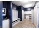 Mudroom with dark blue walls and white storage including a bench with baskets and shelves for shoe storage at 12959 Balfour Rd, Fishers, IN 46037