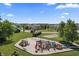 An aerial view of the community playground surrounded by green grass and mature trees at 12959 Balfour Rd, Fishers, IN 46037