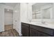 Bathroom features double sinks with dark wood cabinets, white walls, and a closet at 13752 N George Ct, Camby, IN 46113