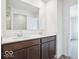 Bathroom features double sinks with dark wood cabinets, white walls, and a shower at 13752 N George Ct, Camby, IN 46113