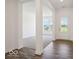 Welcoming entryway featuring dark wood flooring transitioning into carpeted living space with a view to the front door at 13752 N George Ct, Camby, IN 46113