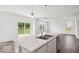 Bright kitchen with white cabinets, stainless steel appliances, and a kitchen island with marble countertops at 13752 N George Ct, Camby, IN 46113