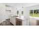 Well-equipped kitchen with stainless steel appliances, white cabinets, and a functional kitchen island at 13752 N George Ct, Camby, IN 46113