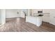 Bright, open-concept living area featuring wood floors, kitchen island, and ample natural light at 13752 N George Ct, Camby, IN 46113