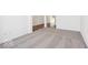 Spacious living area featuring neutral carpeting, fresh white walls, and hardwood flooring in the adjacent entry hall at 13752 N George Ct, Camby, IN 46113