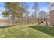 Expansive backyard with lush green grass leading to a serene pond and a spacious deck at 1527 Canyon Oak Ln, Columbus, IN 47201