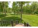 Stunning view of the backyard and pond, seen from the deck stairs, surrounded by lush greenery at 1527 Canyon Oak Ln, Columbus, IN 47201