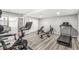 Home gym featuring exercise equipment and sliding doors with a view to the living room at 1527 Canyon Oak Ln, Columbus, IN 47201