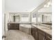 Bright bathroom with double sinks, garden tub, neutral-toned tile flooring, and natural light from windows at 1527 Canyon Oak Ln, Columbus, IN 47201