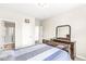 Bedroom featuring neutral walls, a wood bed, and access to a shower room with glass door at 1527 Canyon Oak Ln, Columbus, IN 47201
