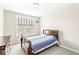 Cozy bedroom with a wood sleigh bed, blue patterned bedding, neutral walls and carpet, and a window view at 1527 Canyon Oak Ln, Columbus, IN 47201