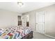 A cozy bedroom with a patterned quilt and ample storage space at 1527 Canyon Oak Ln, Columbus, IN 47201